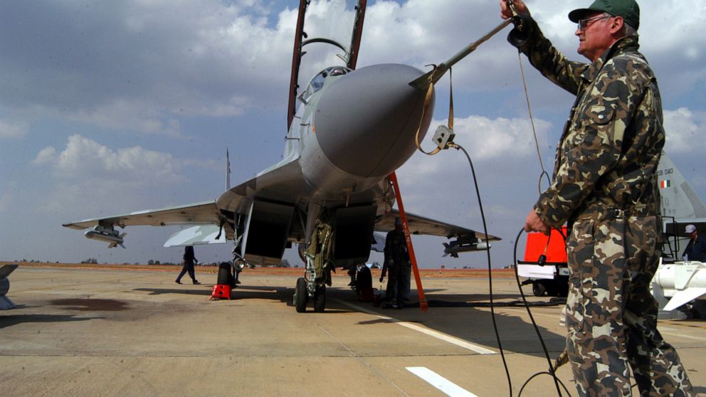 FILE- A Russian technician prepares for the take-off of the MIG 29 M2 ahead of the 5th edition of the Aero India show at the Yelahanka Air Force Station in Bangalore, India, Feb. 6, 2005. India on Thursday said it would ramp up its production of mili