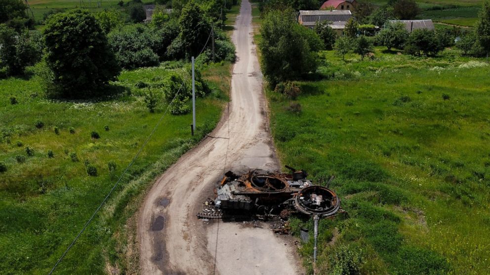 The remains of a destroyed tank sits abandoned on a road in Lypivka, on the outskirts of Kyiv, Ukraine, Tuesday, June 14, 2022. (AP Photo/Natacha Pisarenko)