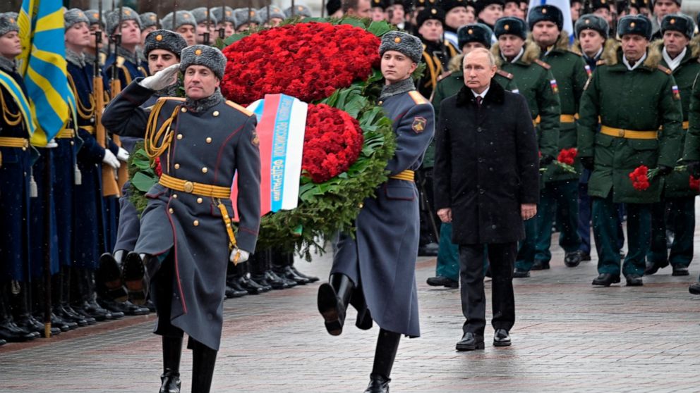 Russian President Vladimir Putin, center right, attends a wreath-laying ceremony at the Tomb of the Unknown Soldier, near the Kremlin Wall during the national celebrations of the 'Defender of the Fatherland Day' in Moscow, Russia, Wednesday, Feb. 23,