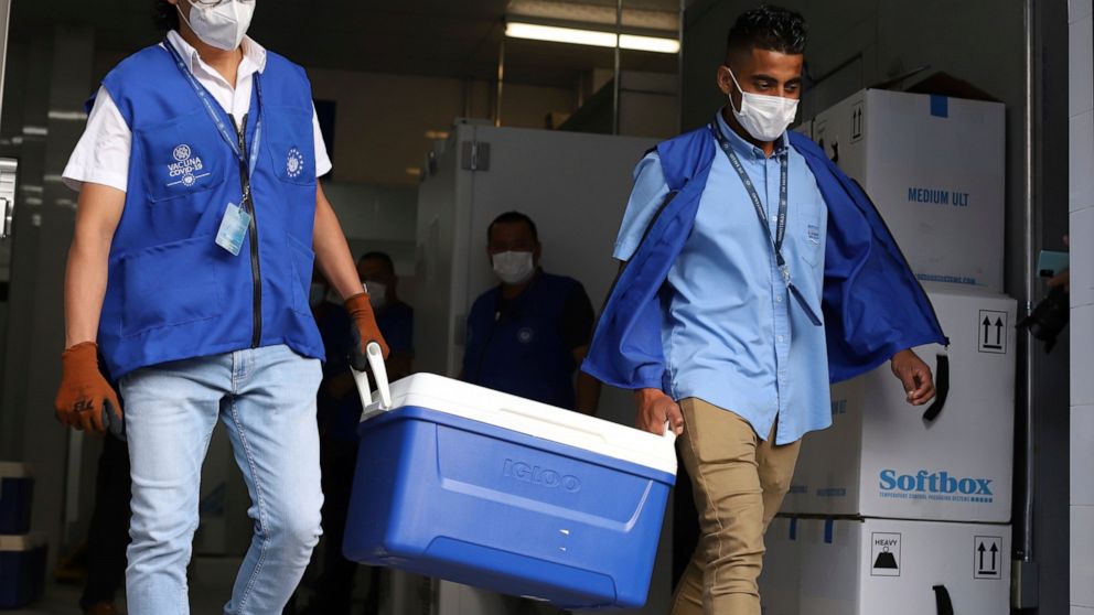 Health Ministry workers carry coolers of COVID-19 vaccines that El Salvador's government is donating to Honduras as they load trucks that will depart San Salvador, El Salvador, Thursday, May 13, 2021. (AP Photo/Salvador Melendez)