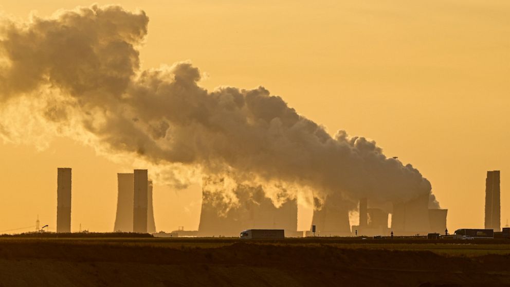 FILE - In this Oct. 1, 2021, file photo, a power plant fires coal from the nearby Garzweiler open-cast mine near Luetzerath, western Germany. Dozens of large German companies have urged the country's next government to put in place ambitious policies