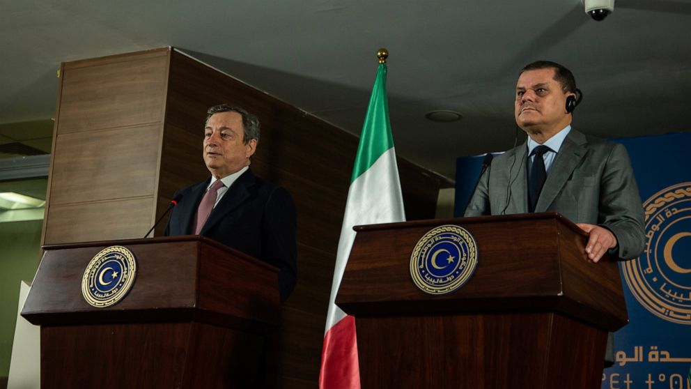 Abdul Hamid Dbeibeh, the Prime Minister of the Government of National Unity, right, and Mario Draghi, the Prime Minister of Italy, speak to media, Tuesday, April, 6 2021 in Tripoli, Libya. (AP Photo/Nada Harib)