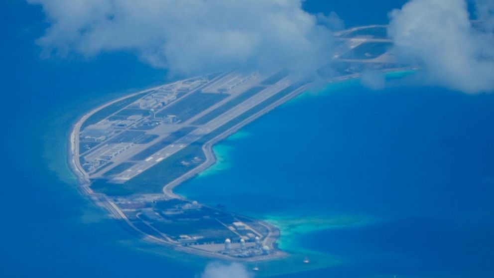 An airstrip made by China is seen beside structures and buildings at the man-made island on Mischief Reef at the Spratlys group of islands in the South China Sea are seen on Sunday March 20, 2022. A U.S. Navy plane carrying a top American military co