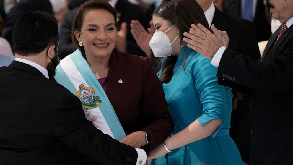 FILE - President Xiomara Castro smiles as she receives the presidential sash, as her husband former President Manuel Zelaya applauds during her inauguration ceremony, in Tegucigalpa, Honduras, Jan. 27, 2022. Castro signed a measure on Monday, April 2