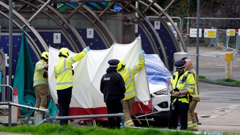 The emergency services erect a tent around the car allegedly involved in an incident near the migrant processing centre in Dover, England, Sunday, Oct. 30, 2022. An attacker threw firebombs an immigration center in the English port town of Dover on S