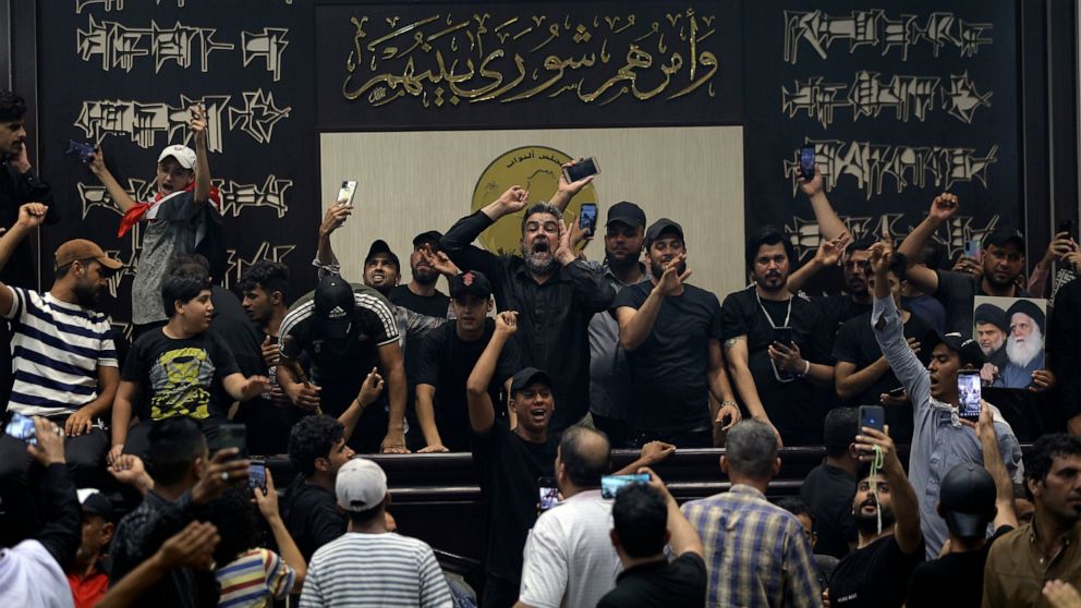 FILE - Iraqi protesters, mostly followers of Shiite cleric Muqtada al-Sadr, fill the parliament building in Baghdad, Iraq, Sunday, July 31, 2022. The political rivals of al-Sadr have declared their own counter-protest. The announcement on Monday stir