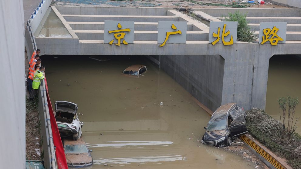 China moves residents out of flooded areas, drains tunnels