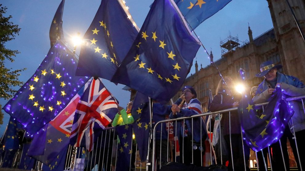 Pro EU protestors wave flags opposite parliament in London, Monday, Sept. 9, 2019. British Prime Minister Boris Johnson voiced optimism Monday that a new Brexit deal can be reached so Britain leaves the European Union by Oct. 31.(AP Photo/Frank Augstein)