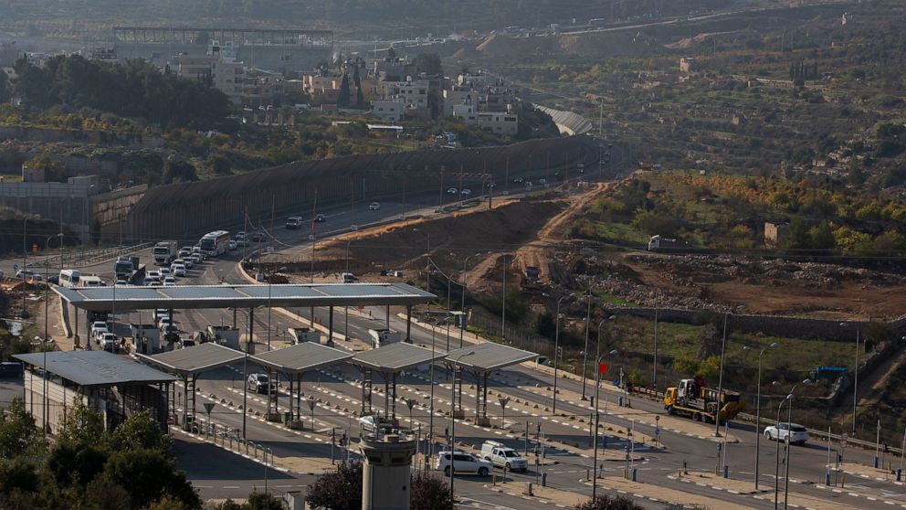 Roadworks expand a road to Israeli settlements inside the West Bank, near the city of Bethlehem, Sunday, Nov. 29, 2020. In years to come, Israelis will be able to commute into Jerusalem and Tel Aviv from settlements deep inside the West Bank via high