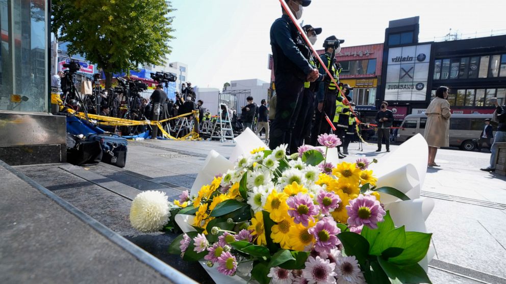 Flowers are seen near the scene of a deadly accident in Seoul, South Korea, Sunday, Oct. 30, 2022, following Saturday night's Halloween festivities. A mass of mostly young people celebrating Halloween festivities in Seoul became trapped and crushed a