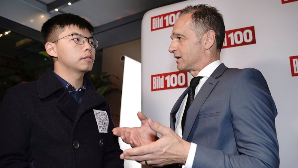 German Foreign Minister Heiko Maas, right, talks to Hong Kong activist Joshua Wong, left, during a reception of a German news paper in Berlin, Germany, Monday, Sept. 9, 2019. Wong will address the media during a press conference in Berlin on Wednesda
