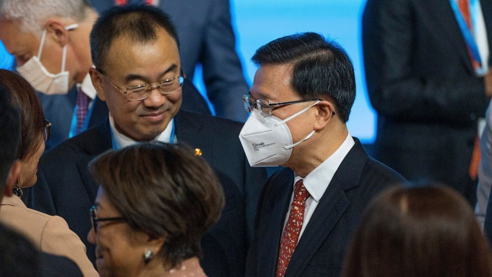 Hong Kong leader John Lee, right, wears a mask as he attends The Global Financial Leaders' Investment Summit in Hong Kong on Wednesday, Nov. 2, 2022. Chinese regulators downplayed China’s real estate slump and slowing economic growth while Hong Kong'