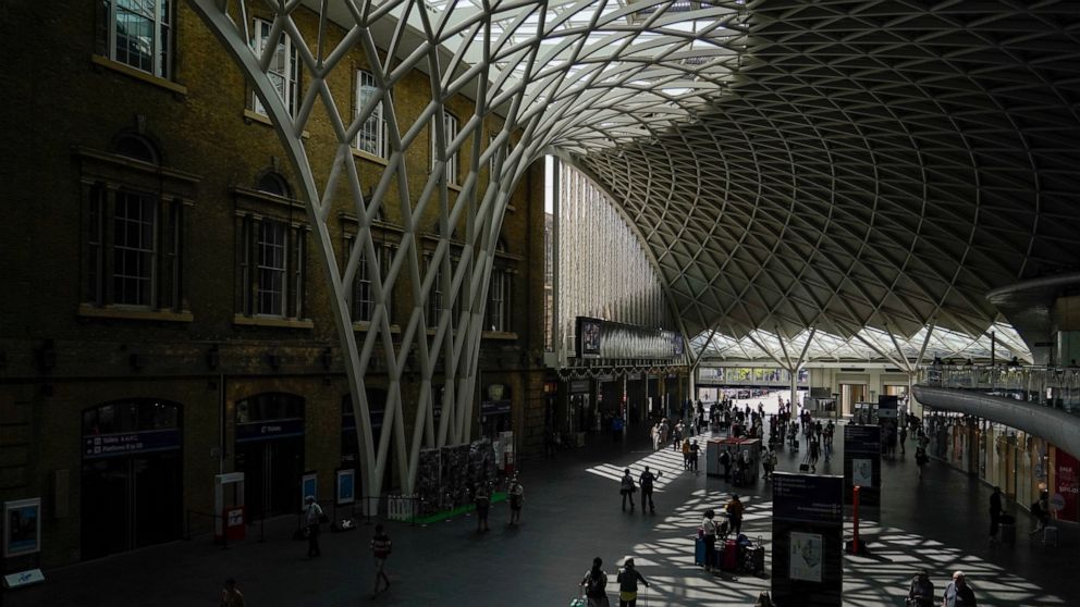Passengers await their trains to be announced, at a quiet King's Cross station, in London, Tuesday, June 21, 2022. Britain's biggest rail strike in decades went ahead Tuesday after last-minute talks between a union and train companies failed to reach