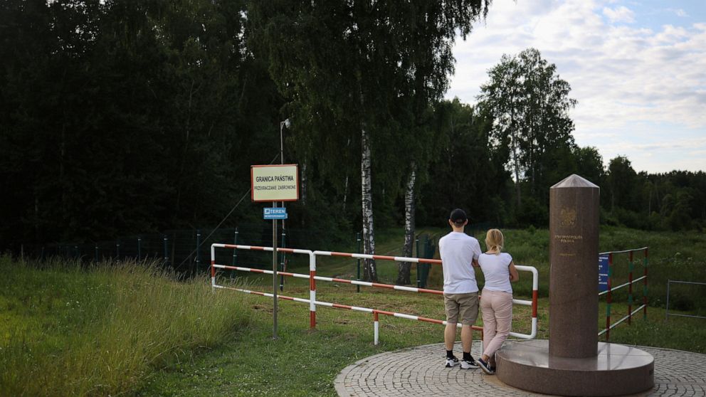 FILE - People visit the area of the place where borders of Poland, Lithuania and Russia's Kaliningrad Oblast meet, in Zerdziny, Poland, on July 7, 2022. Poland's defense minister says he has ordered the construction of a temporary barrier along the b