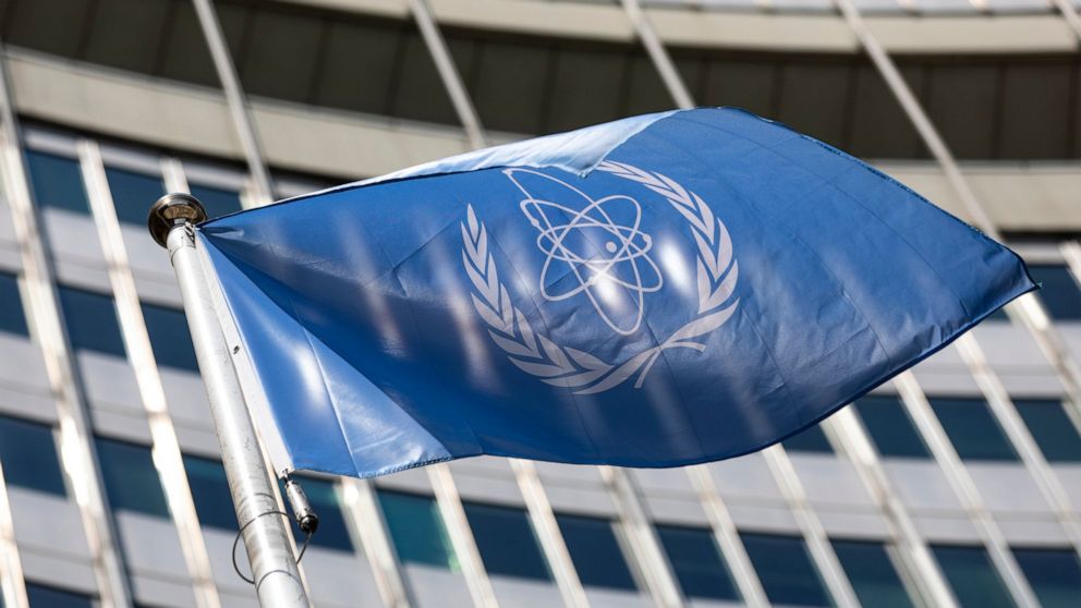 FILE - In this June 7, 2021 file photo the flag of the International Atomic Energy Agency, IAEA waves at the entrance of the Vienna International Center in Vienna, Austria. (AP Photo/Lisa Leutner, file)