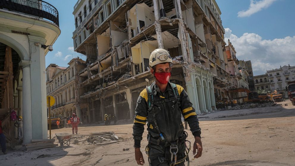 A rescue worker walks away from the destroyed five-star Hotel Saratoga after searching through the rubble days after a deadly explosion in Old Havana, Cuba, Tuesday, May 10, 2022. An apparent gas leak ignited on Friday, May 6. (AP Photo/Ramon Espinosa)