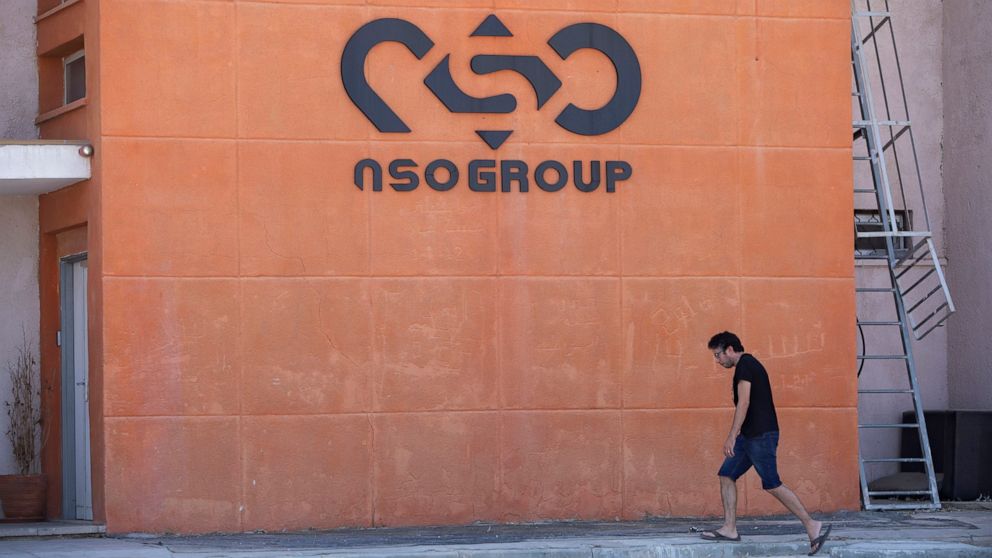 FILE - A logo adorns a wall on a branch of the Israeli NSO Group company, near the southern Israeli town of Sapir, Aug. 24, 2021. The third-largest group in the European Parliament has called for the establishment of a committee to investigate abuses