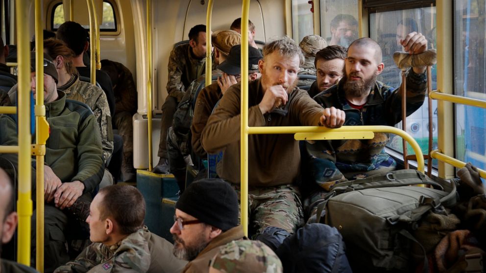 Ukrainian servicemen sit in a bus after they were evacuated from the besieged Mariupol's Azovstal steel plant, near a remand prison in Olyonivka, in territory under the government of the Donetsk People's Republic, eastern Ukraine, Tuesday, May 17, 20