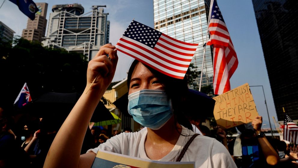 Protesters wave U.S. flags and shout slogans as they march from Chater Garden to the U.S. c\Consulate in Hong Kong, Sunday, Sept. 8, 2019. Demonstrators in Hong Kong plan to march to the U.S. Consulate on Sunday to drum up international support for t