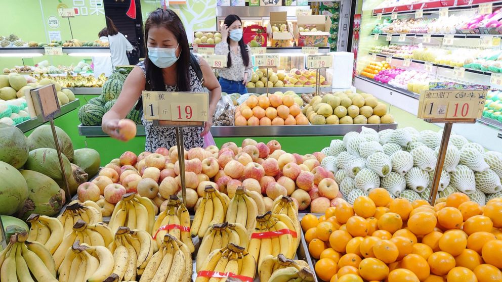 FILE - Customers buy fruit at a stall in Taipei, Taiwan, Sept. 20, 2021. China has blocked imports of citrus and fish from Taiwan in retaliation for a visit to the self-ruled island by a top American lawmaker but avoided sanctions on Taiwanese proces