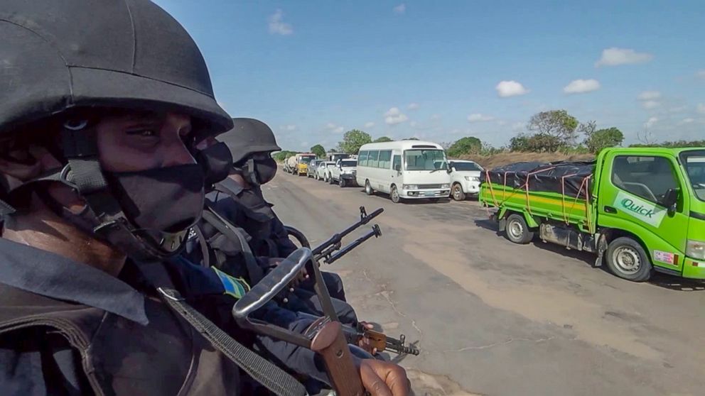 In this image made from video, Rwandan police patrol a road in Palma, Cabo Delgado province, Mozambique, Sunday Aug. 15, 2021. A new offensive by Mozambique's Islamic extremist rebels in Cabo Delgado has increased the number of displaced by 80,000 an