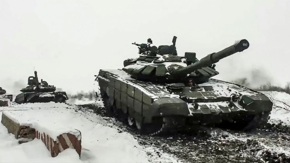 FILE - In this grab taken from video provided by the Russian Defense Ministry Press Service on Wednesday, Jan. 26, 2022, a Russian tanks roll during a military exercising at a training ground in Rostov region, Russia. The Kremlin, which has denied ha