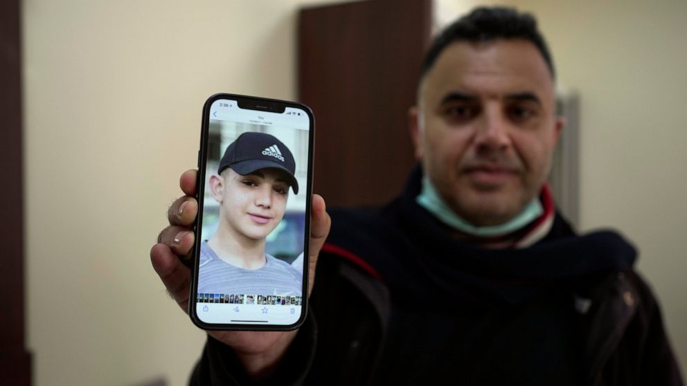 Muamar Nakhleh, father of Amal Nakhleh, a 17-year-old Palestinian with a rare neuromuscular disorder, who has been held without charge for nearly a year in what Israel refers to as "administrative detention," shows his photo at his office, in the Wes
