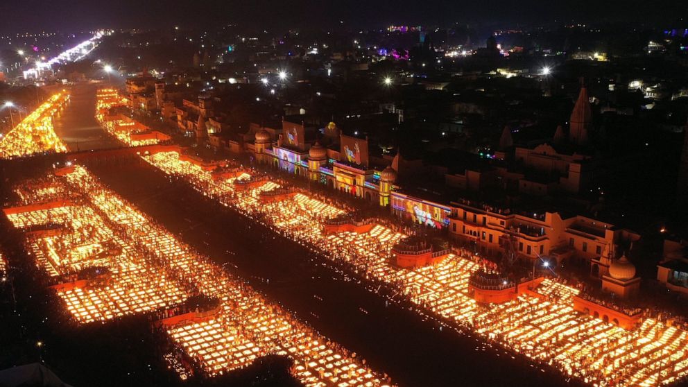 People light lamps on the banks of the river Saryu in Ayodhya, India, Wednesday, Nov. 3, 2021. Over 900,000 earthen lamps were lit and were kept burning for 45 minutes as the north Indian city of Ayodhya retained its Guinness World Record for lightin