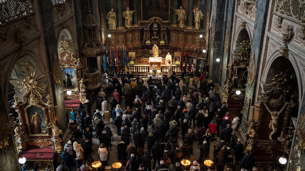 AP PHOTOS: Lviv residents seek comfort in Sunday service