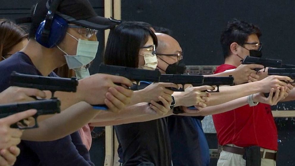 People shoot air soft guns at a private civilian training organization named Polar Light Training in New Taipei City, Taiwan on June 21, 2022. While an invasion doesn’t appear imminent, China's recent large-scale military exercises in response to a v