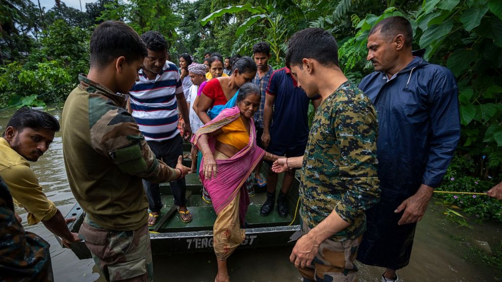 Indian army personnel rescue flood-affected villagers on a boat in Jalimura village, west of Gauhati, India, Saturday, June 18, 2022. More than a dozen people have died as massive floods ravaged northeastern India and Bangladesh, leaving millions of 