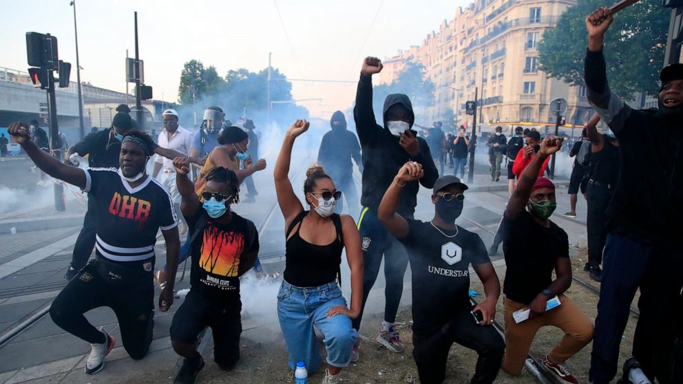 FILE- Protesters gesture during a demonstration against police violence and racial injustice, Tuesday, June 2, 2020 in Paris. France is inducting Missouri-born cabaret dancer Josephine Baker, who was also a French World War II spy and civil rights ac