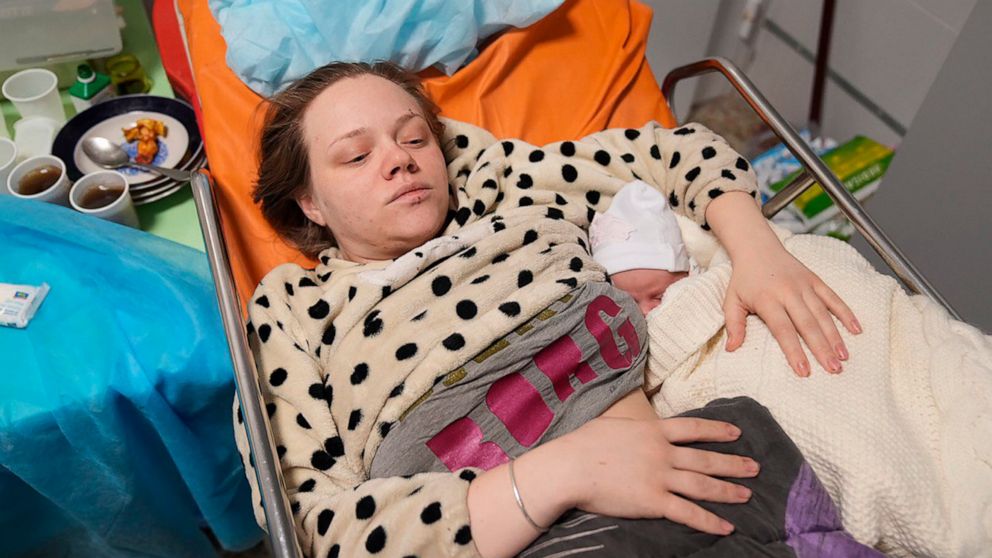 Amid Mariupol horror, a newborn rests in her mother's arms