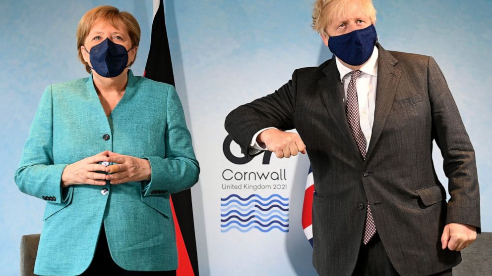 Britain's Prime Minister Boris Johnson, right, greets German Chancellor Angela Merkel ahead of a bilateral meeting during the G7 summit in Cornwall, England, Saturday June 12, 2021. (Stefan Rousseau/Pool via AP)