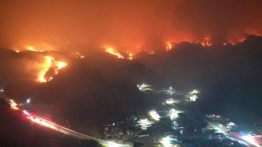 A wildfire burns on a mountain in Samcheok, South Korea, Friday, March 4, 2022. Thousands of South Koreans were forced to flee their homes Friday after a large wildfire ripped through an eastern coastal area and temporarily threatened a nuclear power