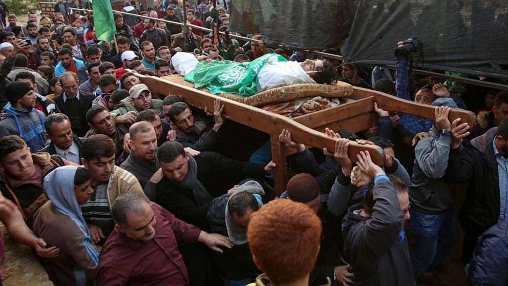 FILE - In this Nov. 15, 2018, file photo, mourners carry the body of Palestinian fisherman Nawaf Al-Attar, 20, who was shot and killed by Israeli troops on the beach near the border with Israel, during his funeral in Beit Lahiya, northern Gaza Strip.