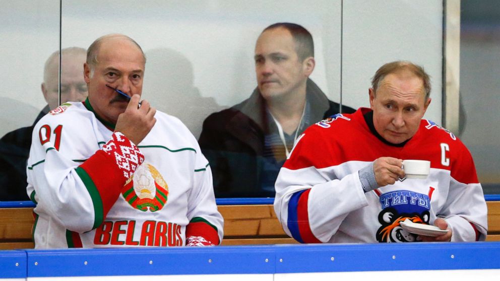 FILE - In this Friday, Feb. 7, 2020 file photo, Russian President Vladimir Putin, right, and Belarusian President Alexander Lukashenko take a break during a match of the Night Hockey League teams in Rosa Khutor in the Black Sea resort of Sochi, Russi