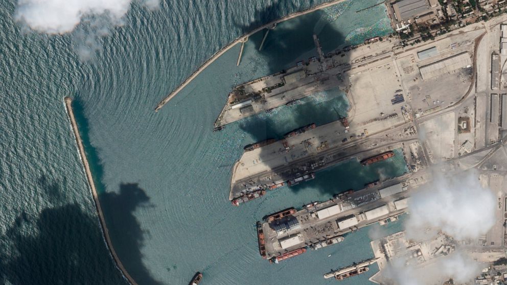 This satellite image from Planet Labs PBC shows the Sierra Leone-flagged cargo ship Razoni, center bottom with four white cranes on its red deck, at port in Tartus, Syria, Monday, Aug. 15, 2022. The first shipment of grain to leave Ukraine under a wa