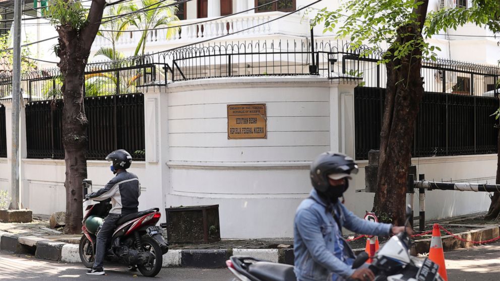 Motorists ride past the Nigerian Embassy in Jakarta, Indonesia, Thursday, Aug. 12, 2021. Indonesia's Foreign Ministry apologized Thursday for the manhandling of a Nigerian diplomat and announced it had launched a formal investigation of the incident.