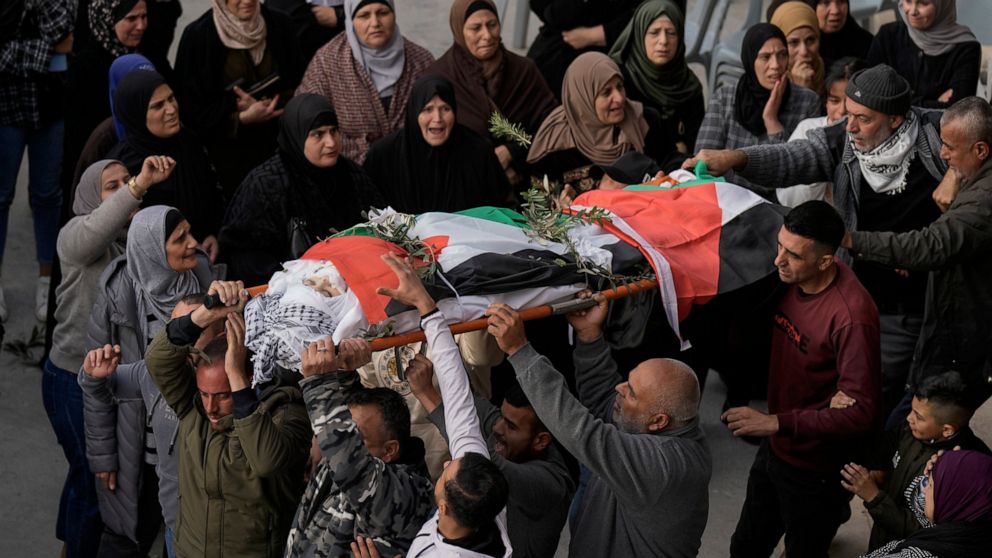 Palestinians carry the body of Jana Zakaran, 16, during her funeral in the West Bank city of Jenin, Monday, Dec. 12, 2022. Palestinian health officials said Zakaran was killed by Israeli fire during a military operation in the occupied West Bank. Pal