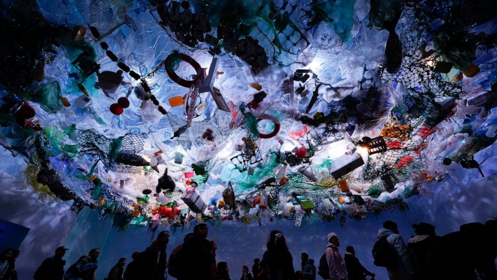 People walk in an exhibit simulating sea pollution during the 11th edition of Technopolis science, technology, industry and art exhibit in Buenos Aires, Argentina, Sunday, July 17, 2022. (AP Photo/Natacha Pisarenko)