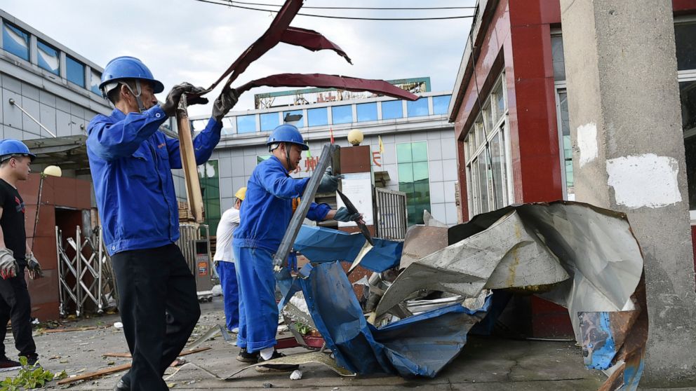 Workers clear debris at a factory that was damaged by a reported tornado in Shengze township in Suzhou in eastern China's Jiangsu Province, Saturday, May 15, 2021. Two tornadoes killed several people in central and eastern China and left hundreds of 