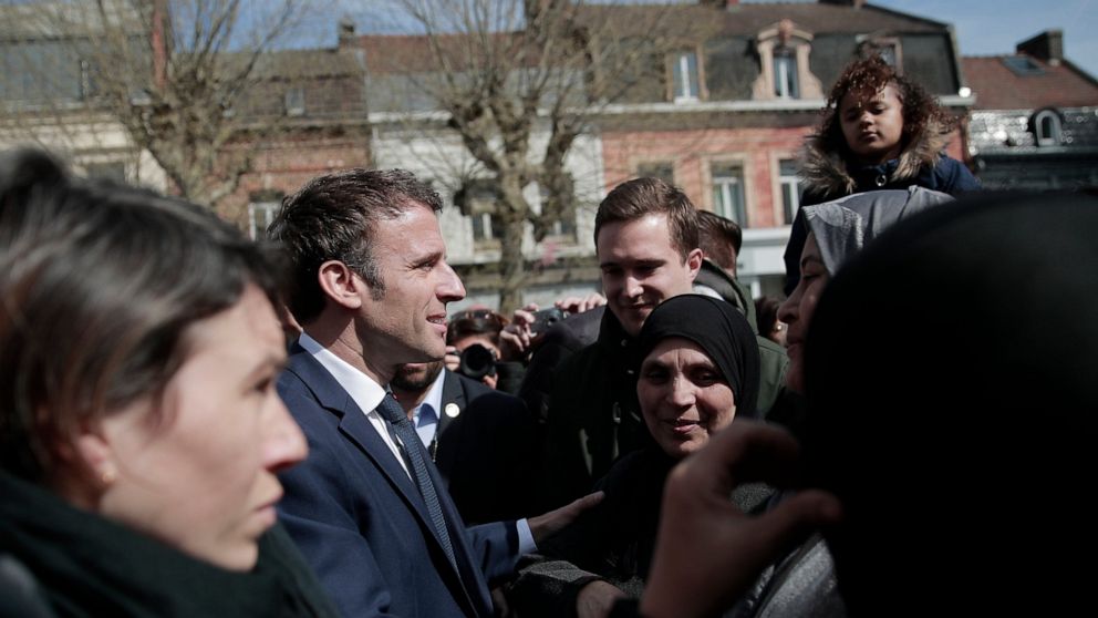 Current French President and centrist presidential candidate for reelection Emmanuel Macron meets residents in Denain, northern France, Monday, April 11, 2022 . French President Emmanuel Macron may be ahead in the presidential race so far, but he war