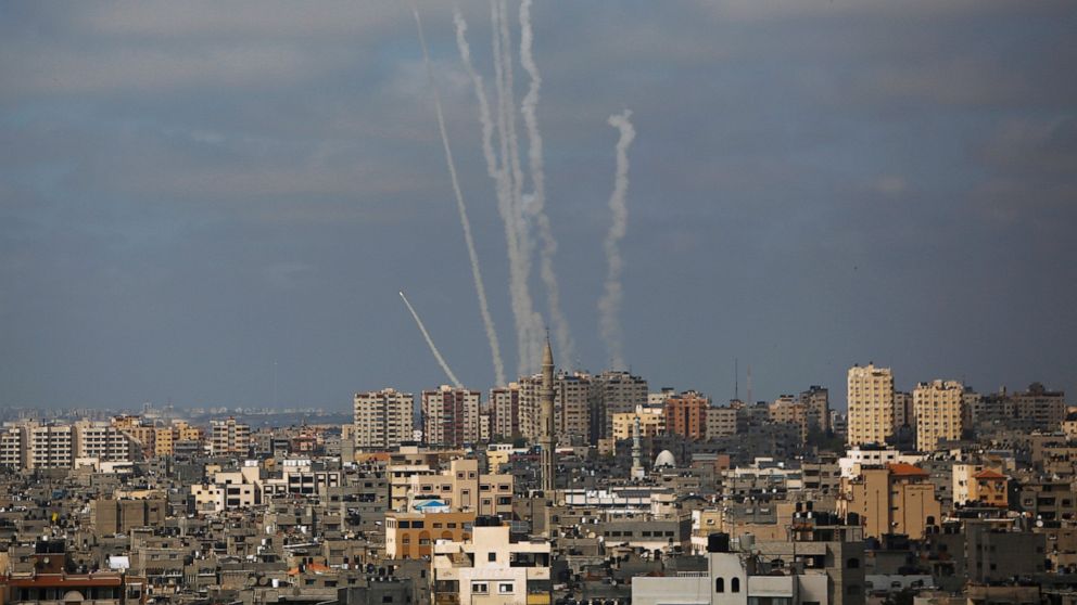 FILE - In this May 20, 2021 file photo, rockets are launched from the Gaza Strip towards Israel, in Gaza City, Human Rights Watch said Thursday, Aug. 12, 2021, that the thousands of rockets fired by the Palestinian militant group Hamas during the 11-