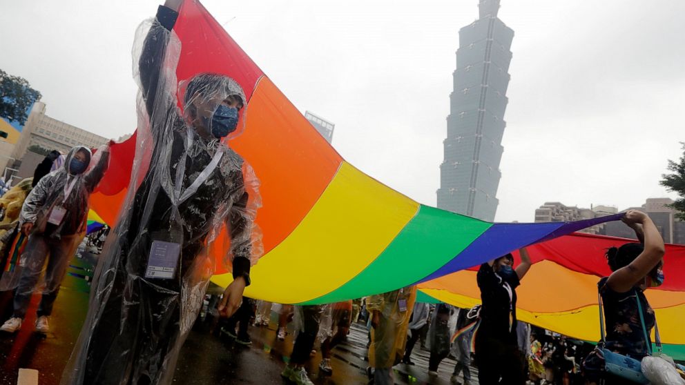 Participants revel through a street during the annual Taiwan LGBT Pride parade in Taipei, Taiwan, Saturday, Oct. 29, 2022. (AP Photo/Chiang Ying-ying)