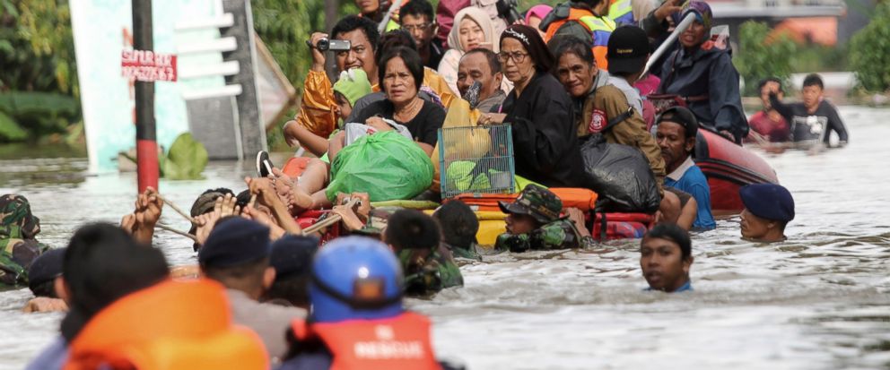 Residents ride a makeshift raft as they evacuate their flooded homes in Makassar, South Sulawesi, Indonesia, Wednesday, Jan. 23, 2019.(AP Photo/Masyudi Syachban Firmansyah)