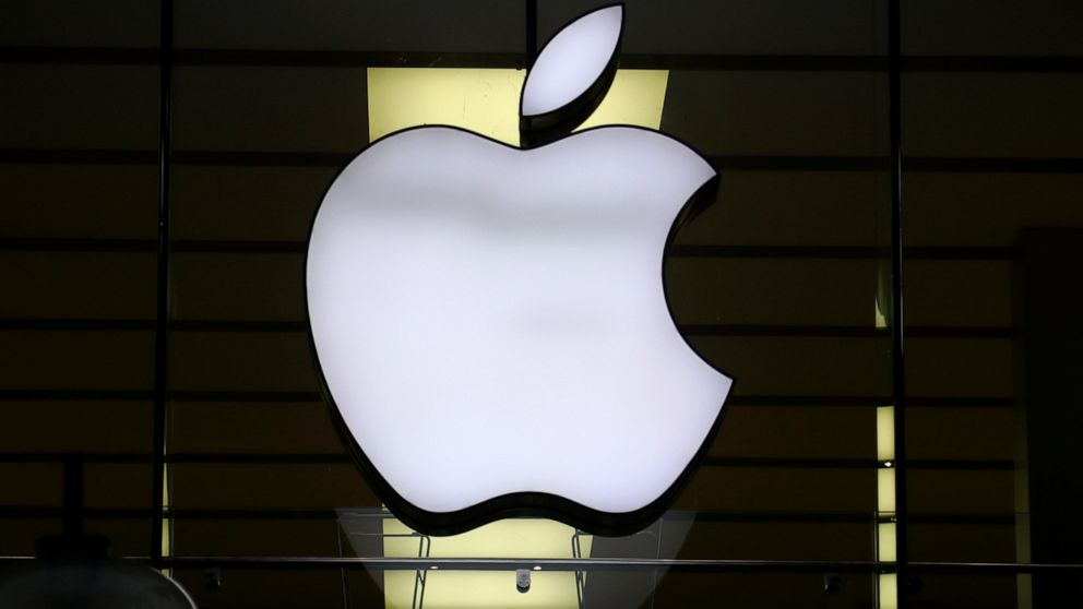 FILE - In this Wednesday, Dec. 16, 2020 file photo, the logo of Apple is illuminated at a store in the city center in Munich, Germany. Apple said Friday, Sept. 3, 2021 it's delaying its plan to scan U.S. iPhones for images of child sexual abuse, sayi