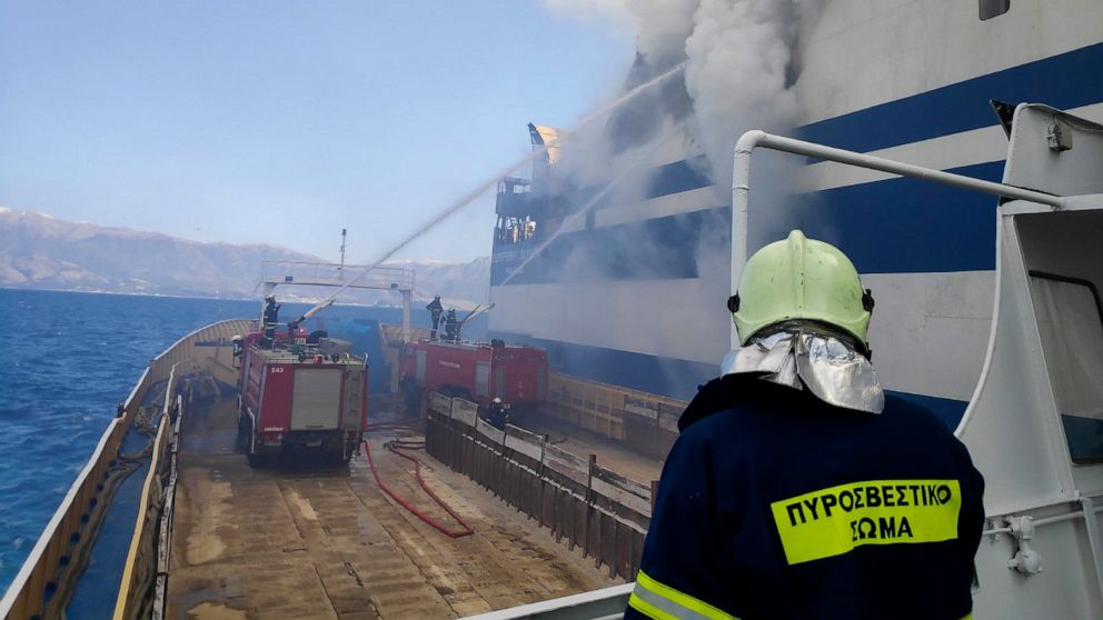 Greek rescuers search burning ferry for 12 missing people