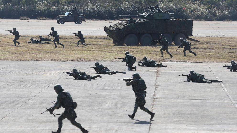 Soldiers take part in a military exercise in Hsinchu County, northern Taiwan, Tuesday, Jan. 19, 2021. Taiwanese troops using tanks, mortars and small arms staged a drill Tuesday aimed at repelling an attack from China, which has increased its threats