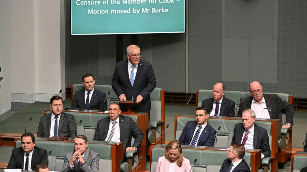 Former Australian Prime Minister Scott Morrison, standing at rear, speaks during a censure motion against him in the House of Representatives at Parliament House in Canberra, Australia, Wednesday, Nov. 30, 2022. Morrison has listed his achievements i